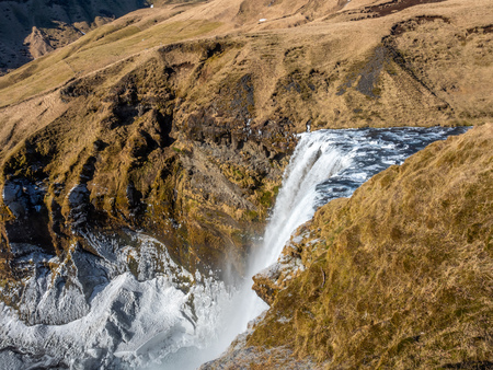 Top view of Skogafoss waterfall with snow and ice in winter season in Icelandの写真素材