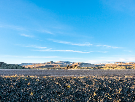 Road with surrounding view of nature in Iceland, mountain and fieldの写真素材