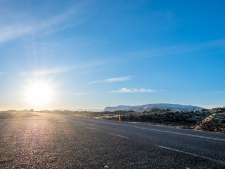 Road with surrounding view of nature in Iceland, mountain and fieldの写真素材