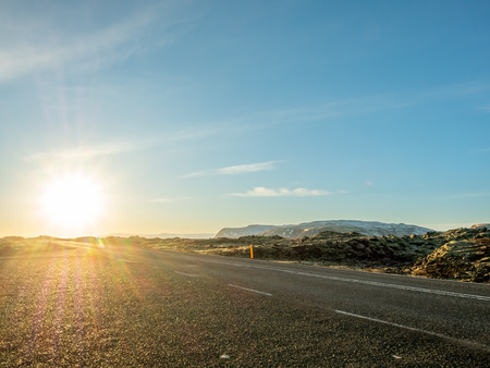 Road with surrounding view of nature in Iceland, mountain and fieldの写真素材