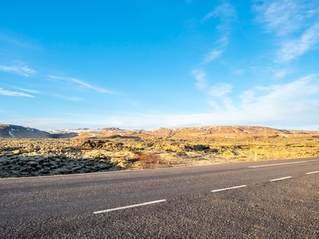 Road with surrounding view of nature in Iceland, mountain and fieldの写真素材