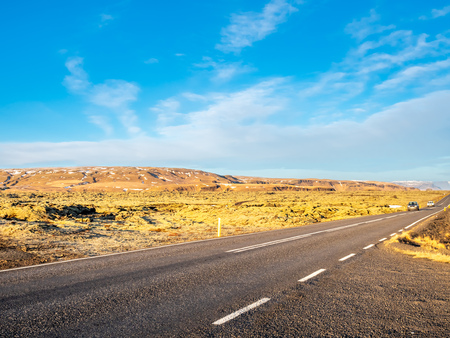 Road with surrounding view of nature in Iceland, mountain and fieldの写真素材