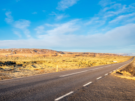 Road with surrounding view of nature in Iceland, mountain and fieldの写真素材