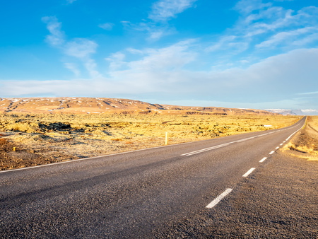 Road with surrounding view of nature in Iceland, mountain and fieldの写真素材