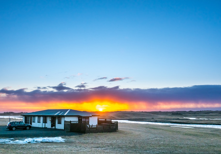 Natural view of mountain and field in outdoor farm under twilight evening sky in Iceland during winter seasonの写真素材