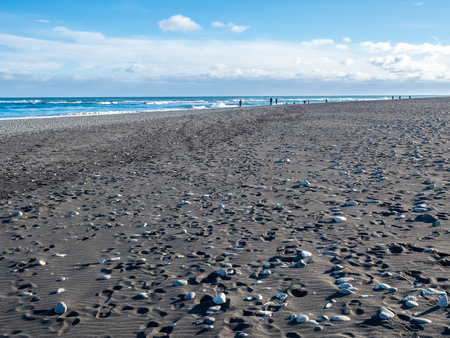 Black sand diamond beach with wave and snow mountains in winter season in Icelandの写真素材