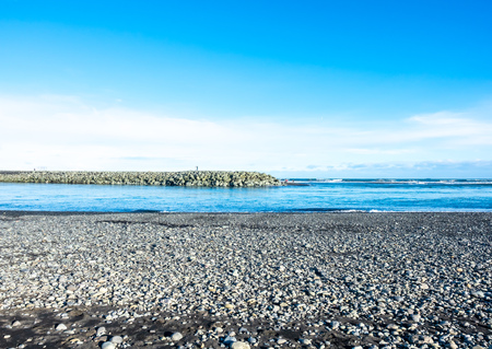 Black sand diamond beach with wave and snow mountains in winter season in Icelandの写真素材