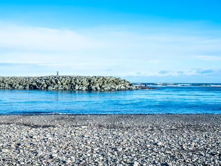 Black sand diamond beach with wave and snow mountains in winter season in Icelandの写真素材