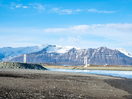 Black sand diamond beach with wave and snow mountains in winter season in Icelandの写真素材
