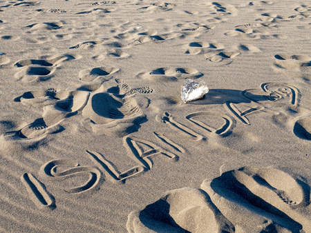 ISLANDA handwriting on black sand beach in winter season in Icelandの写真素材