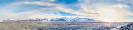 Viewpoint to Hvannadalshnukur peak, with wide plain of black volcanic sand marbled with creeks of run-off from the Skeioararjokull glacierの写真素材