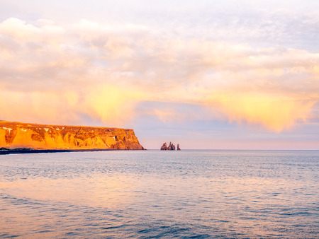 Coastline view with mountains near Dyrholaey, Vik town in Iceland, during twilight evening sky in winter seasonの写真素材