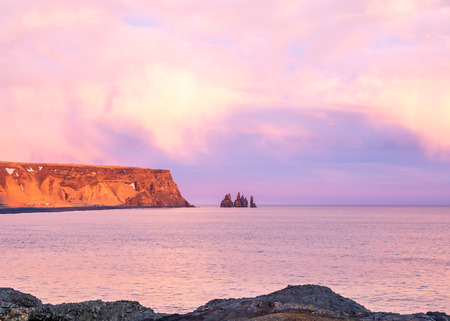 Coastline view with mountains near Dyrholaey, Vik town in Iceland, during twilight evening sky in winter seasonの写真素材