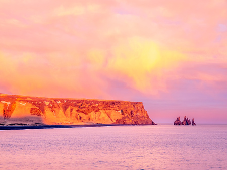 Coastline view with mountains near Dyrholaey, Vik town in Iceland, during twilight evening sky in winter seasonの写真素材