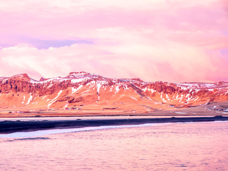 Coastline view with mountains near Dyrholaey, Vik town in Iceland, during twilight evening sky in winter seasonの写真素材