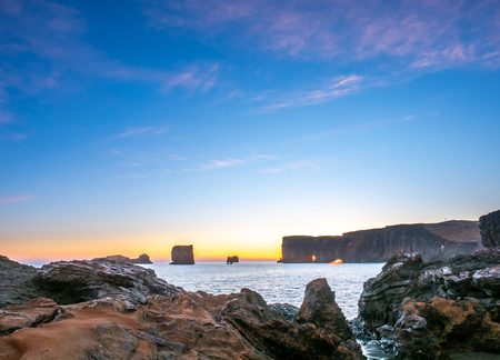 Dyrholaey arch, mean 'the hill island with the door hole', amazing geology viewpoint near Vik town at south of Iceland, during twilight evening sky along coastlineの写真素材