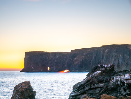 Dyrholaey arch, mean 'the hill island with the door hole', amazing geology viewpoint near Vik town at south of Iceland, during twilight evening sky along coastlineの写真素材