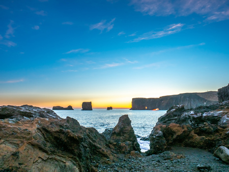 Dyrholaey arch, mean 'the hill island with the door hole', amazing geology viewpoint near Vik town at south of Iceland, during twilight evening sky along coastlineの写真素材