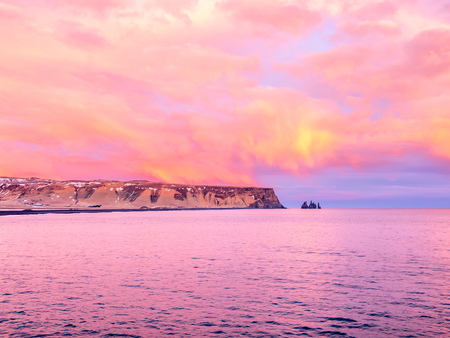 Coastline view with mountains near Dyrholaey, Vik town in Iceland, during twilight evening sky in winter seasonの写真素材