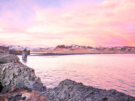 Coastline view with mountains near Dyrholaey, Vik town in Iceland, during twilight evening sky in winter seasonの写真素材