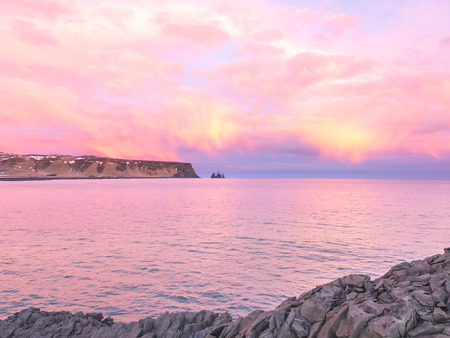 Coastline view with mountains near Dyrholaey, Vik town in Iceland, during twilight evening sky in winter seasonの写真素材