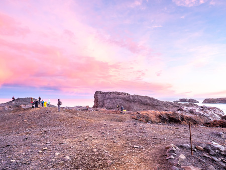 Coastline view with mountains near Dyrholaey, Vik town in Iceland, during twilight evening sky in winter season, with unrecognized touristsのeditorial素材