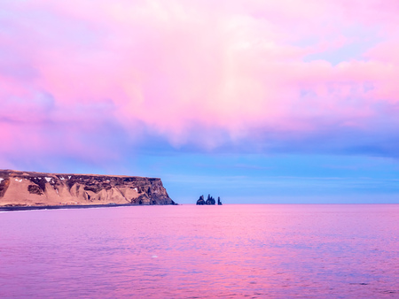 Coastline view with mountains near Dyrholaey, Vik town in Iceland, during twilight evening sky in winter seasonの写真素材