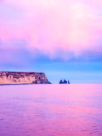 Coastline view with mountains near Dyrholaey, Vik town in Iceland, during twilight evening sky in winter seasonの写真素材
