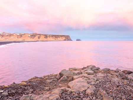 Coastline view with mountains near Dyrholaey, Vik town in Iceland, during twilight evening sky in winter seasonの写真素材