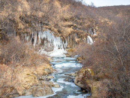 Frozen river in Skaftafell national park, near Svartifoss waterfall in winter season of Icelandの写真素材