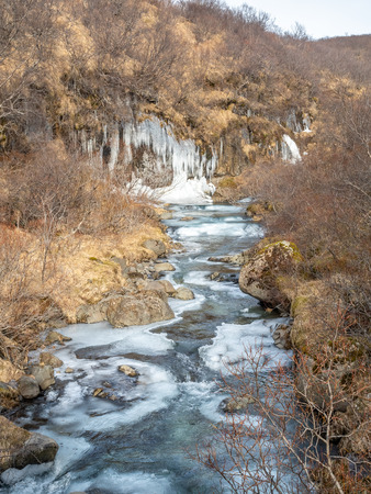Frozen river in Skaftafell national park, near Svartifoss waterfall in winter season of Icelandの写真素材