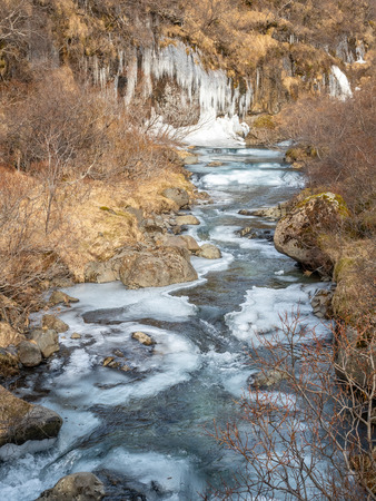 Frozen river in Skaftafell national park, near Svartifoss waterfall in winter season of Icelandの写真素材