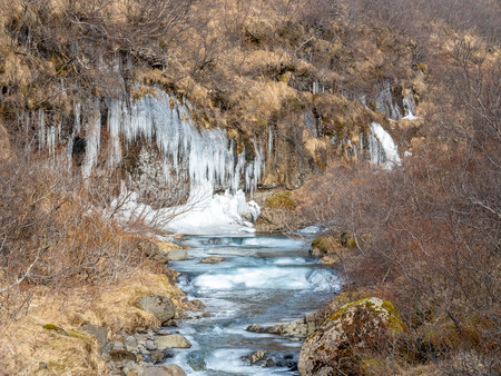 Frozen river in Skaftafell national park, near Svartifoss waterfall in winter season of Icelandの写真素材