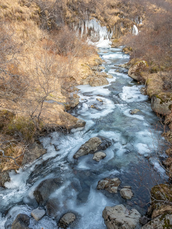 Frozen river in Skaftafell national park, near Svartifoss waterfall in winter season of Icelandの写真素材