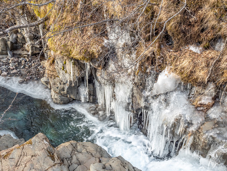 Frozen river in Skaftafell national park, near Svartifoss waterfall in winter season of Icelandの写真素材
