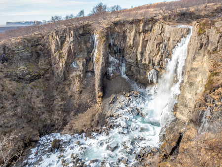 Hundafoss waterfall near Svartifoss in winter season with frozen river, one of destination landmark in Icelandの写真素材