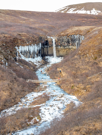 Svartifoss waterfall, one of unique landmark in Iceland, located in Vatnajokull national park, like oasis in black larva sand plain, water freeze in winter seasonの写真素材