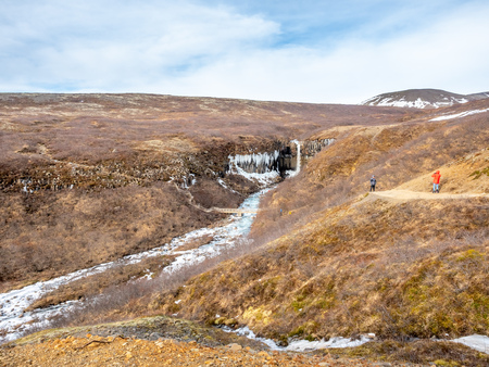Svartifoss waterfall, one of unique landmark in Iceland, located in Vatnajokull national park, like oasis in black larva sand plain, water freeze in winter seasonの写真素材