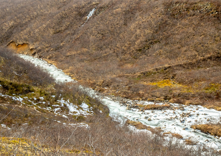 Frozen river in Skaftafell national park, near Svartifoss waterfall in winter season of Icelandの写真素材