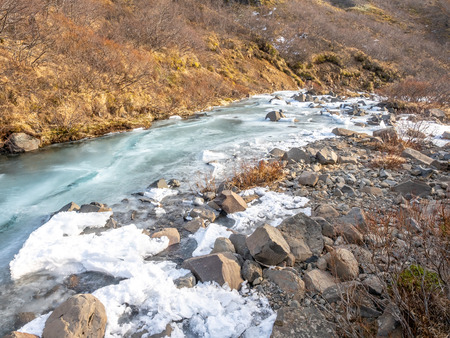 Frozen river in Skaftafell national park, near Svartifoss waterfall in winter season of Icelandの写真素材