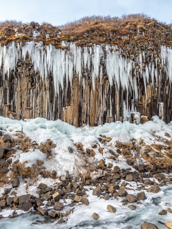Frozen waterfall at columnar basalt rock in Skaftafell national park, near Svartifoss waterfall in winter season in Icelandの写真素材