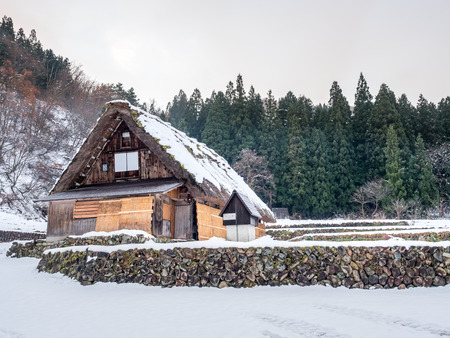 Gassho-zukuri unique architecture house in Shirakawa village, the UNESCO world heritage place, with snow in early winter season in Gifu, Japanのeditorial素材