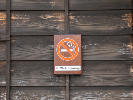 Non-smoking sign on wooden wall for backgroundの写真素材