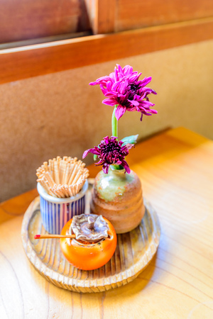 Purple flower in small vase decorated on restaurant tableの写真素材