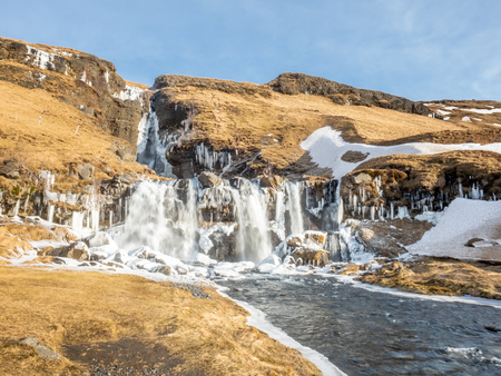 Gluggafoss, large waterfall, in winter season under blue sky in Icelandの写真素材