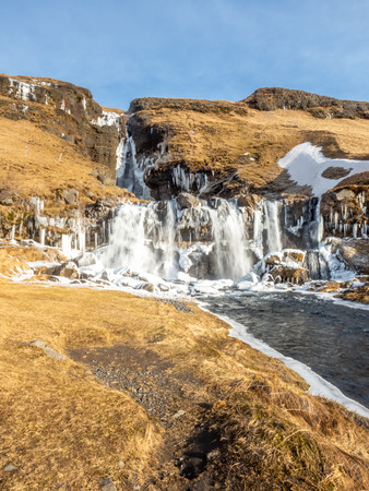 Gluggafoss, large waterfall, in winter season under blue sky in Icelandの写真素材