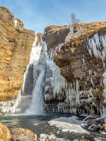 Gluggafoss, large waterfall, in winter season under blue sky in Icelandの写真素材