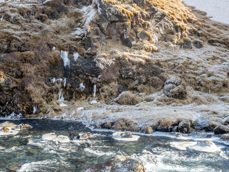 Frozen snow at mountain cliff at Gluggafoss waterfall in winter season, Icelandの写真素材