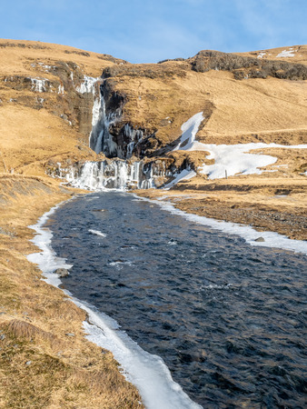 Gluggafoss, large waterfall, in winter season under blue sky in Icelandの写真素材