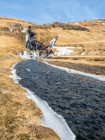 Gluggafoss, large waterfall, in winter season under blue sky in Icelandの写真素材